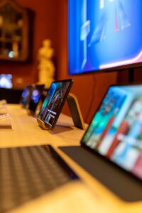 Close-up of modern tablets displayed on a wooden table in an electronics store.